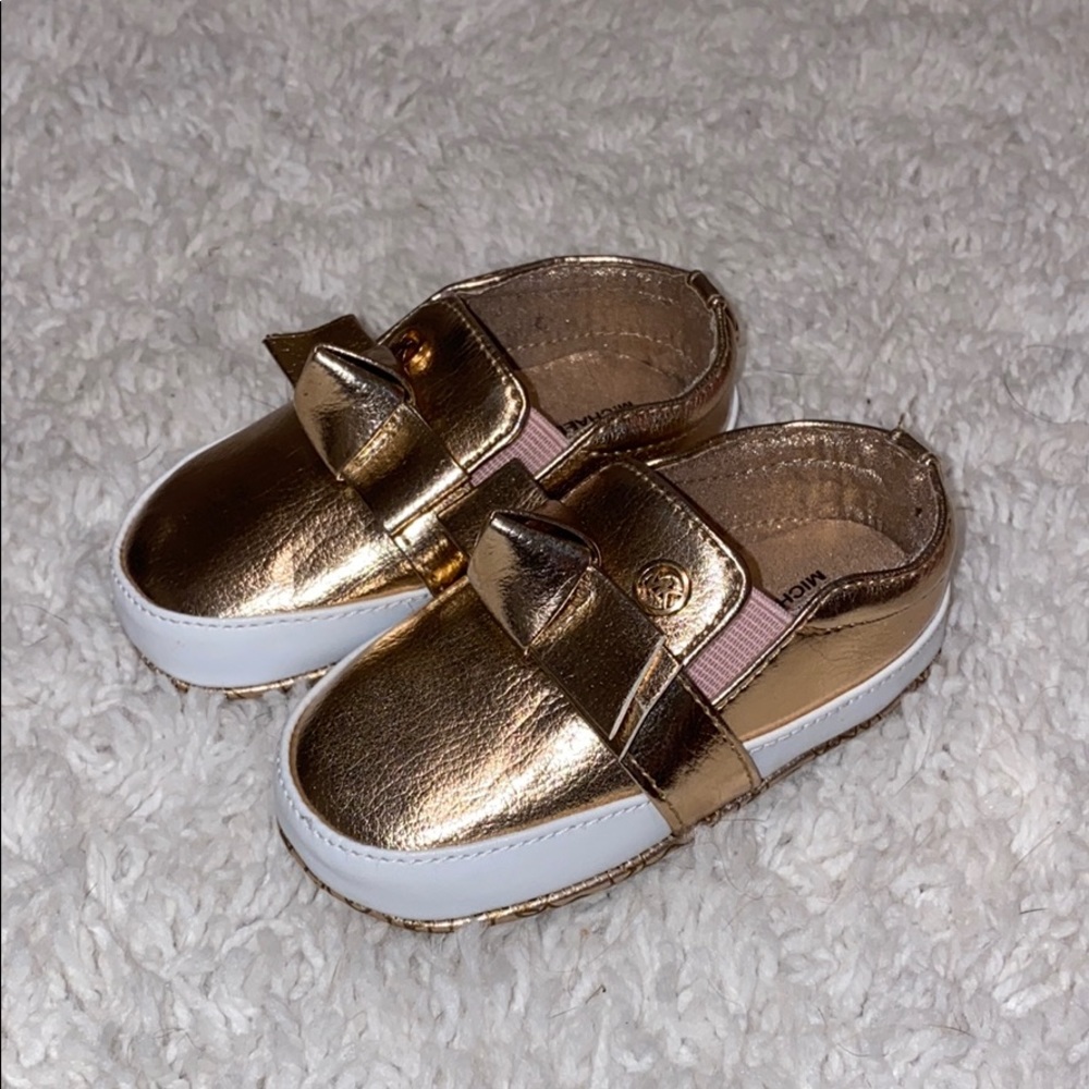 NWOT rose gold Michael Kors “baby poppy” shoes